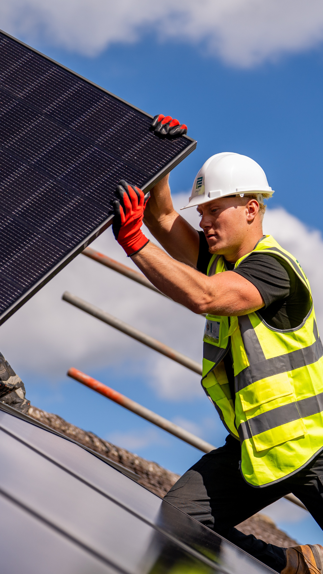A Pro-Fit installer fixing solar panels to a domestic pitched roof